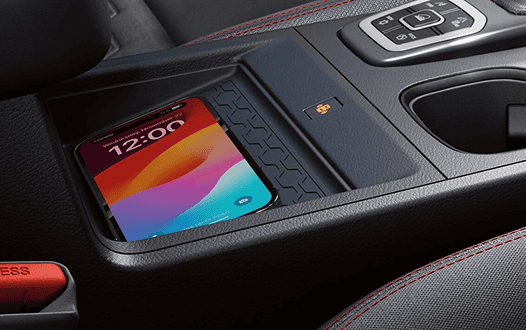 Smartphone on the wireless charging pad in the center console