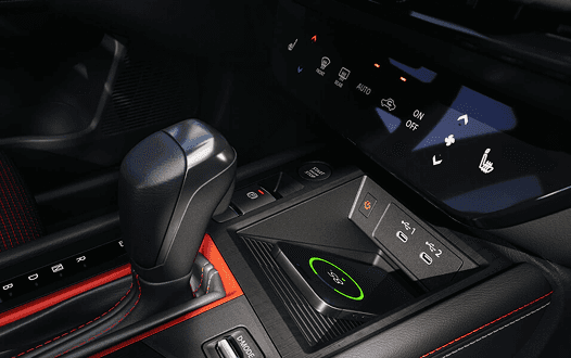 Kicks center console with gear shifter, climate controls, and wireless charging pad