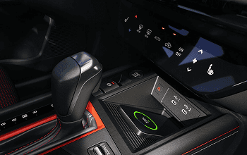 Kicks center console with gear shifter, climate controls, and wireless charging pad