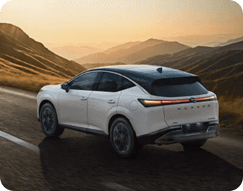 Rear three-quarter view of a white Murano driving on a mountain road