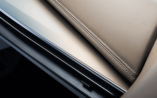 Close-up of Murano two-tone tan and black leather dashboard stitching