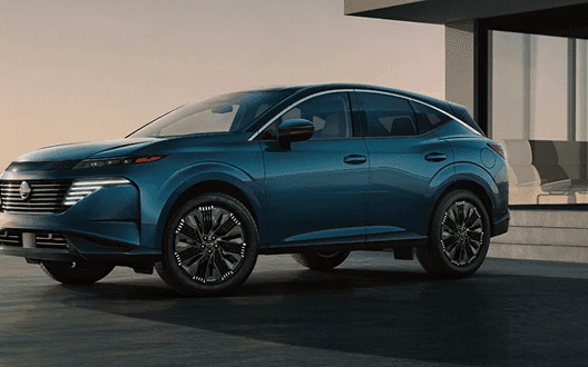 Front three-quarter view of a blue Murano parked outside a modern home