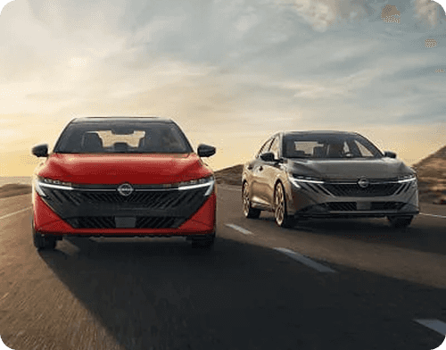 Red and gray Sentras driving side by side on a highway
