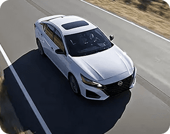 Aerial view of white 2026 Nissan Altima on highway