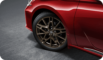 Close-up of bronze 19-inch alloy wheel on red Altima