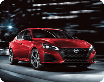 Red 2026 Nissan Altima at night with city lights