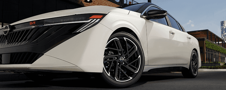 Side profile of a white Sentra SR with black machined-finish wheels