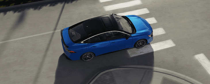 Top-down view of a blue Sentra at a crosswalk intersection