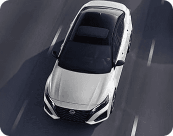 Overhead view of white Nissan Altima on road