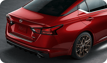 Rear view of red Nissan Altima with roof spoiler