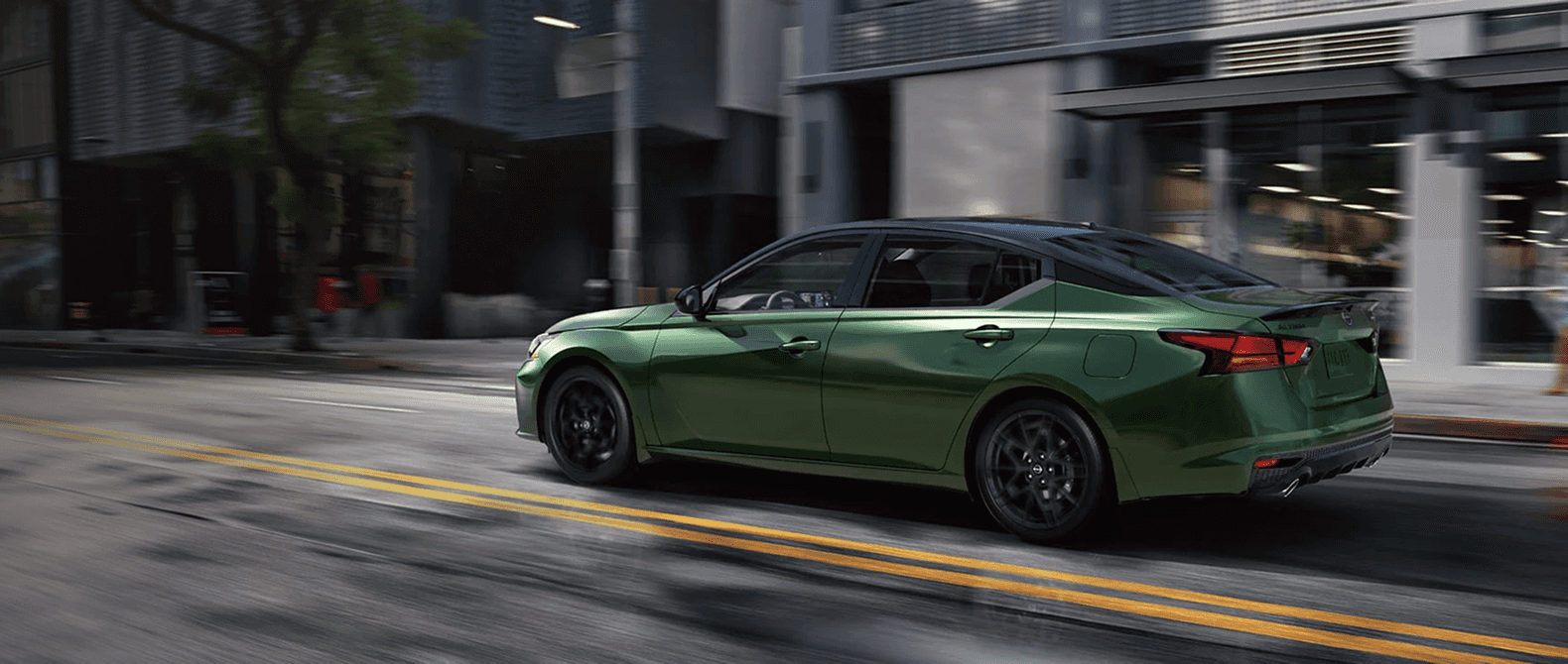 Green 2026 Nissan Altima driving on city street