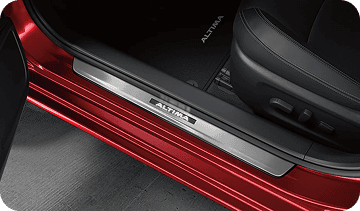 Illuminated door sill kick plate on red car
