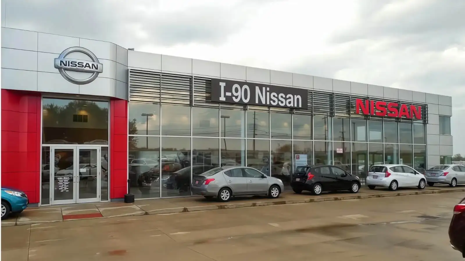 I-90 Nissan storefront at 5013 Detroit Rd, Sheffield Village — Nissan logo and red I-90 Nissan signage on a glass-fronted dealership