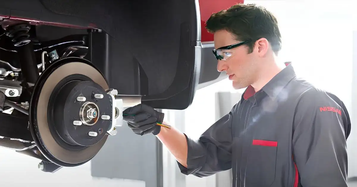Checking the brakes in the 100k Nissan periodic maintenance service checklist