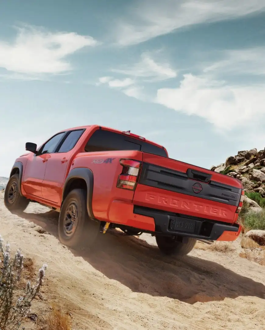 2026 Nissan Frontier climbing a rocky desert trail, rear angle — midsize pickups for sale at I-90 Nissan, Sheffield Village, OH