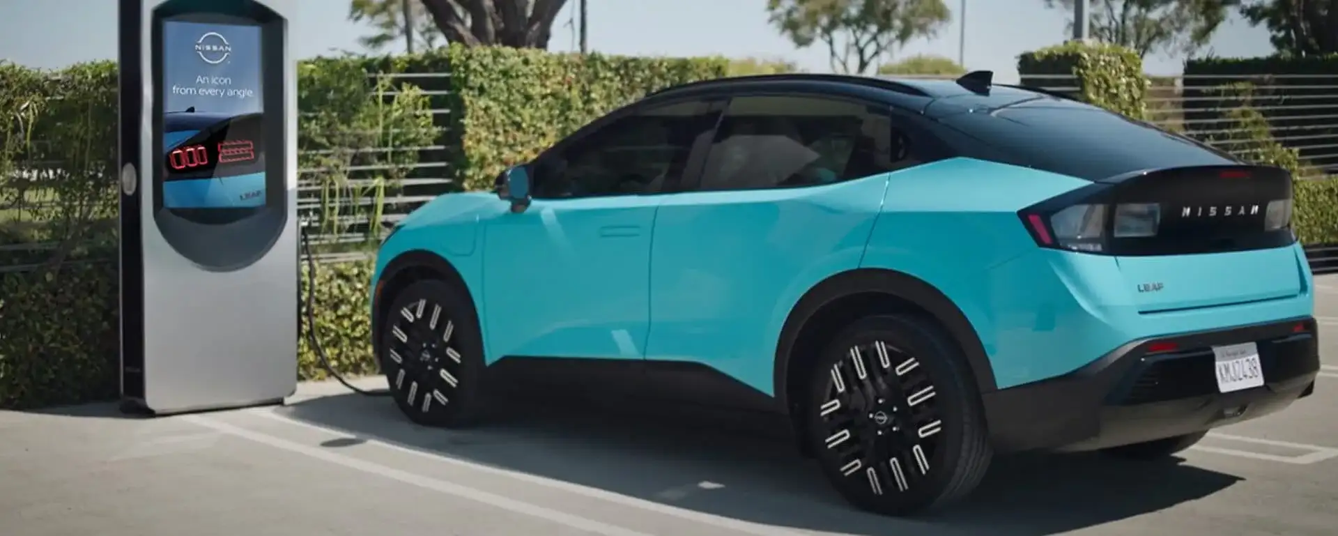 2026 Nissan Leaf plugged into a DC fast charger, charging via the NACS connector