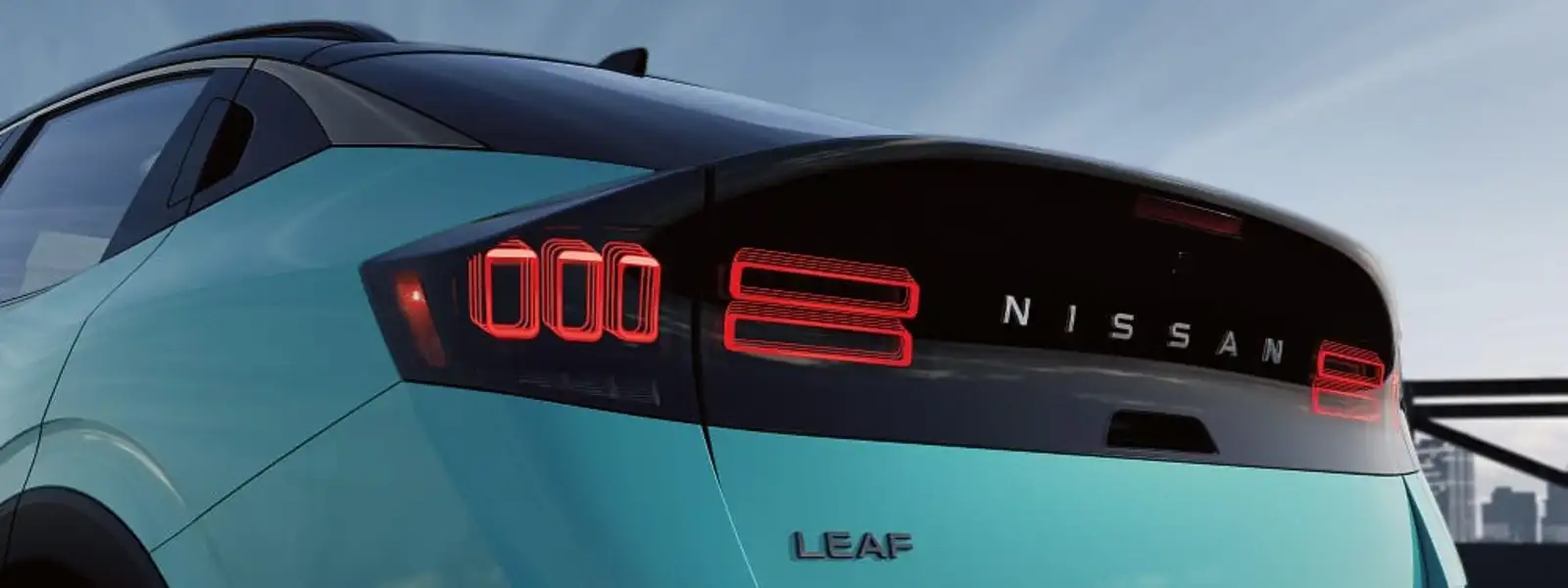 Rear taillight detail of the 2026 Nissan Leaf showing the full-width lightbar and LEAF badge