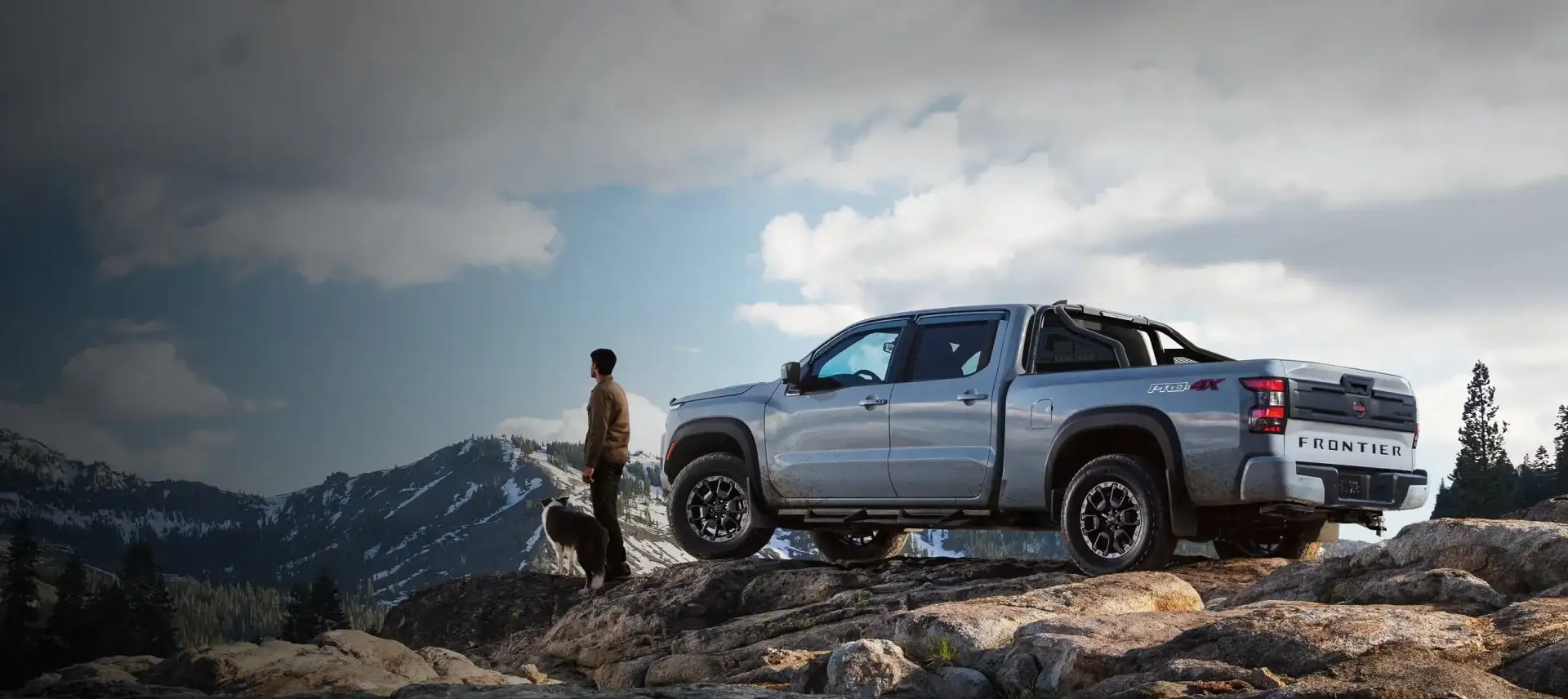 2026 Nissan Frontier PRO-4X 4WD pickup parked on a snowy alpine ridge, the kind of cold-weather 4WD capability I-90 Nissan buyers rely on through northeast Ohio winters