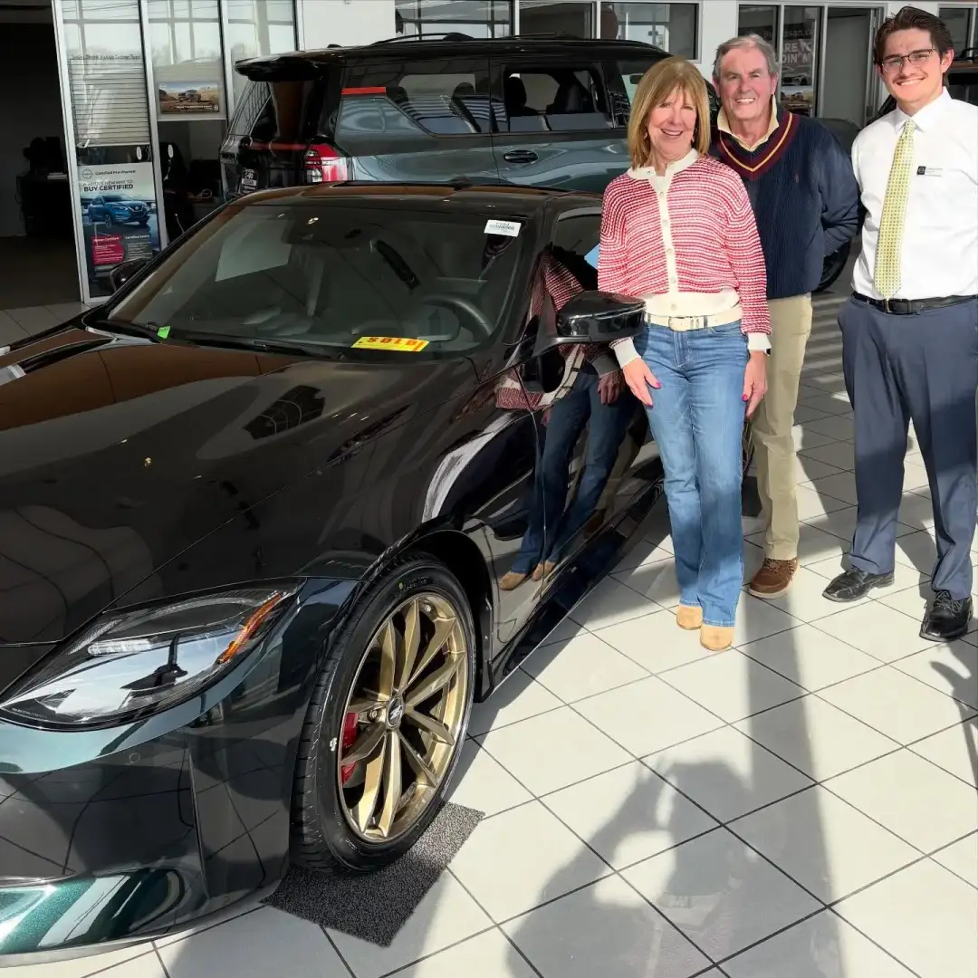 Janet and James taking delivery of their 2026 Nissan Z Heritage Edition with their I-90 Nissan salesperson in the Sheffield Village showroom