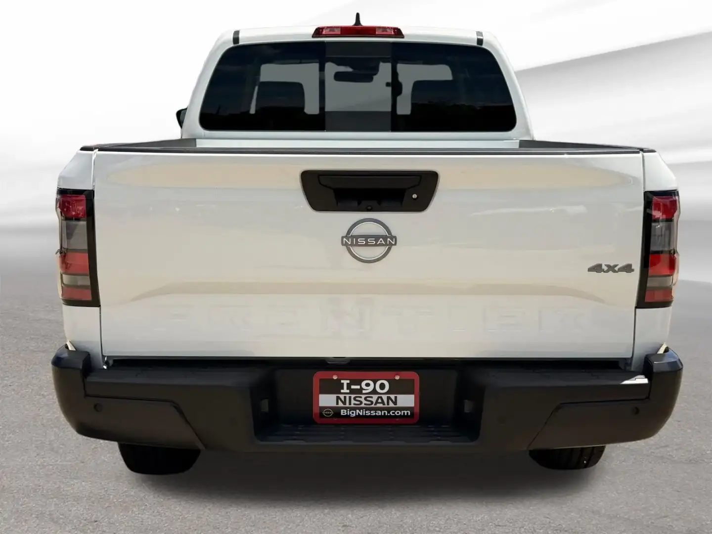 Straight rear view of the 2026 Nissan Frontier tailgate with backup camera and 4x4 badge