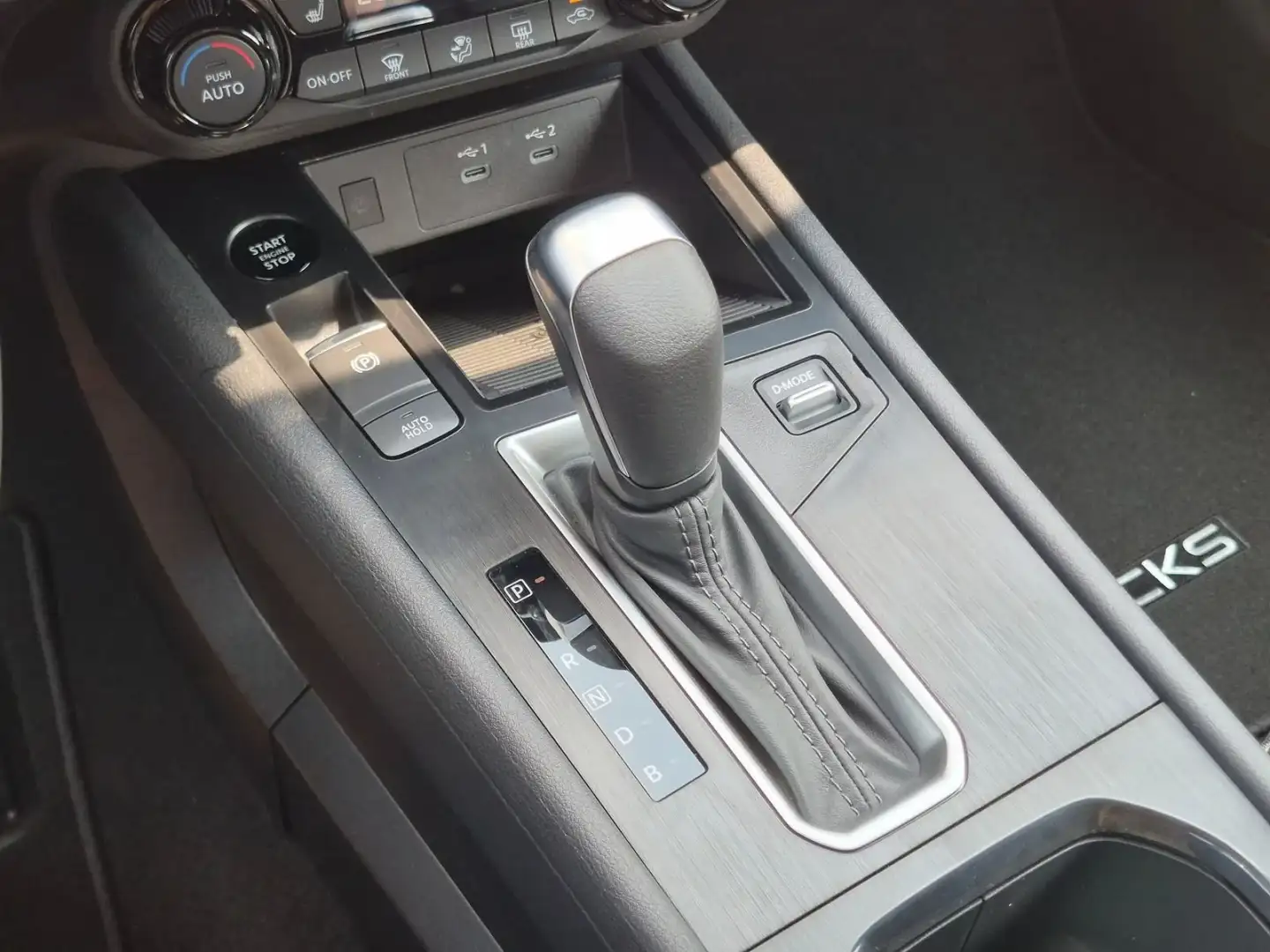 Nissan Kicks center console and gear selector with the KICKS trim detail