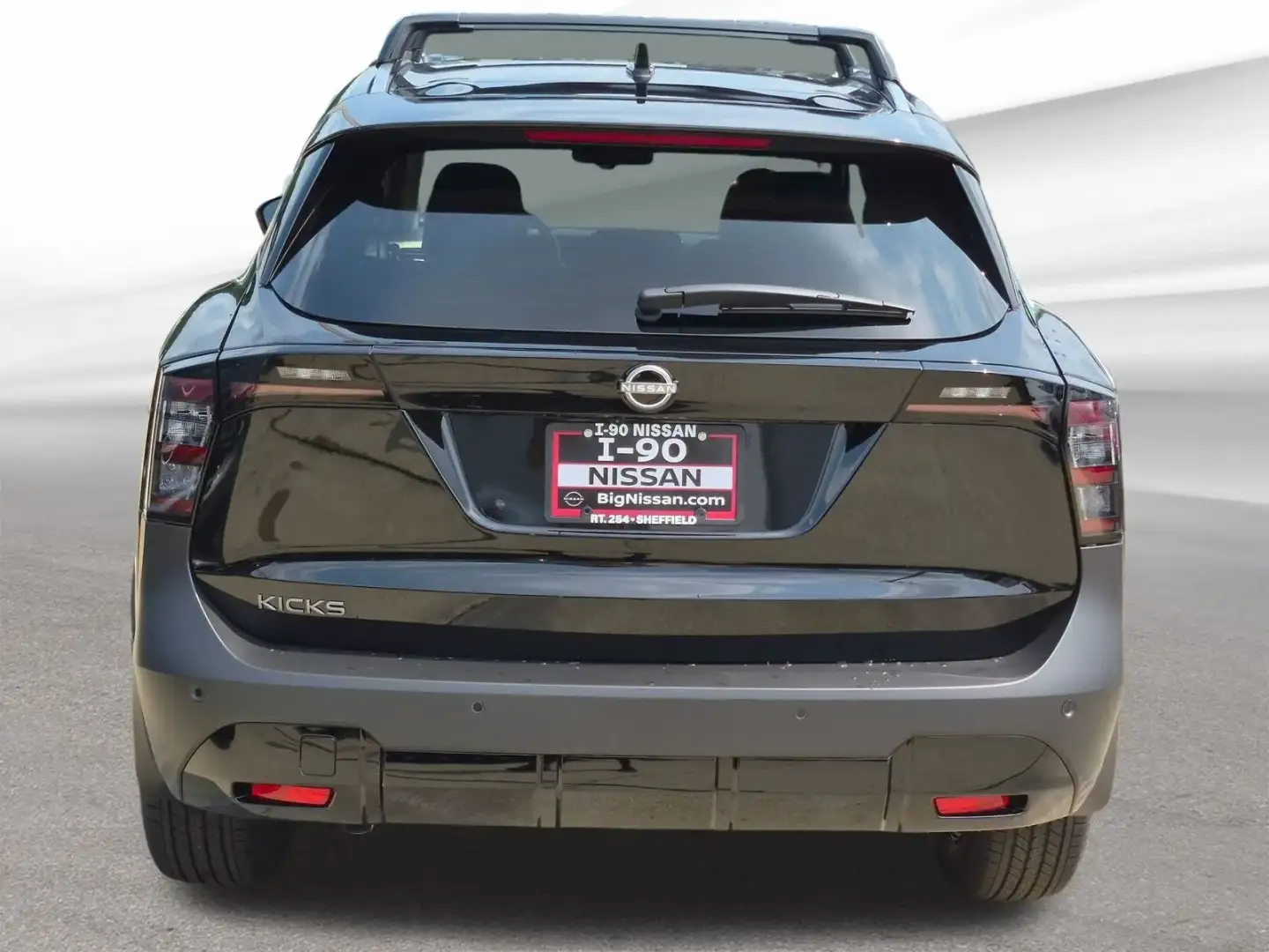 Nissan Kicks in gunmetal gray, rear view showing the tailgate and lights