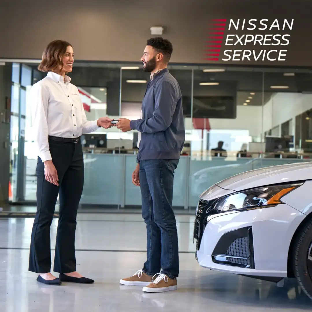 A customer being met at the indoor service drive at I-90 Nissan