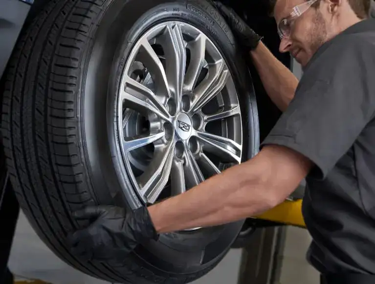 A Cadillac tire being serviced.