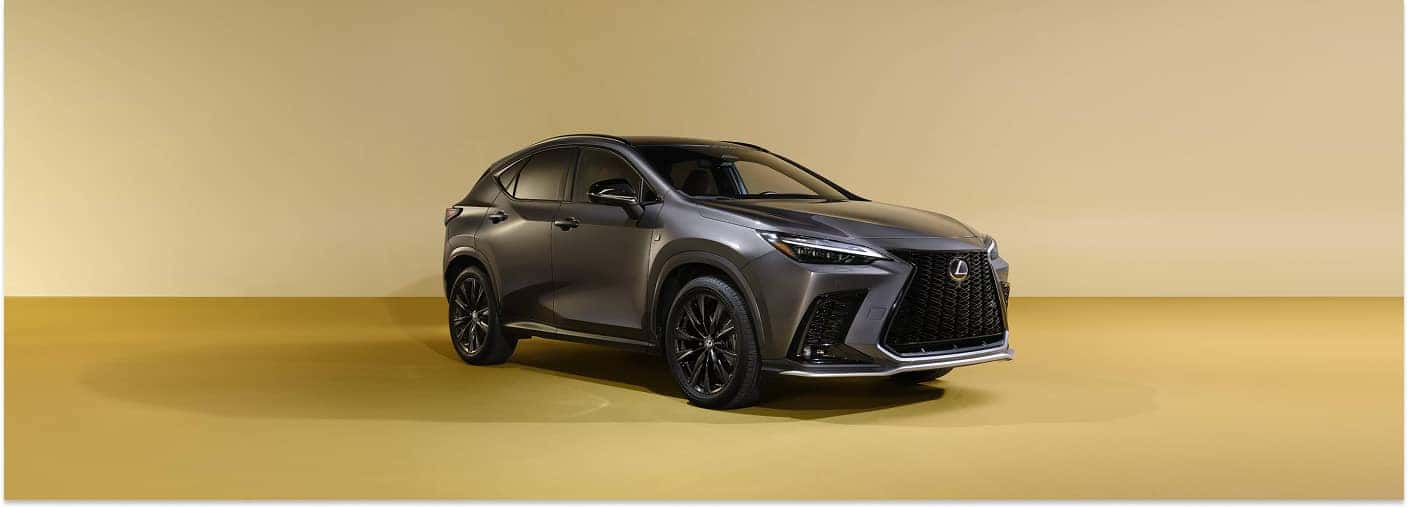 Front three-quarter view of a dark gray 2026 Lexus NX SUV in a studio setting.