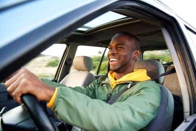 man behind the wheel of a new car