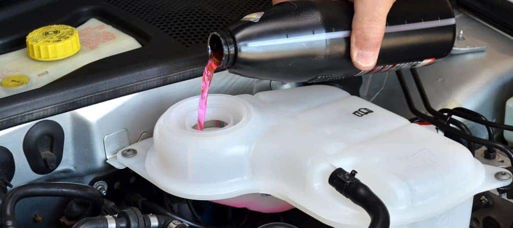 technician adding coolant