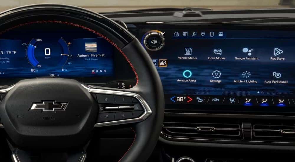A close-up of the steering wheel and infotainment screen in a 2025 Chevy Equinox EV.