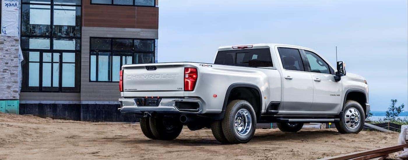 A white 2025 Chevy Silverado 3500 for sale is shown from the rear at an angle.