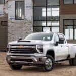 A white 2025 Chevy Silverado 3500 for sale is shown from the front at an angle.