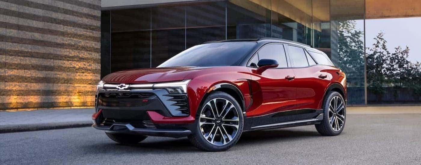 A red 2024 Chevy Blazer EV RS is shown parked on a driveway.