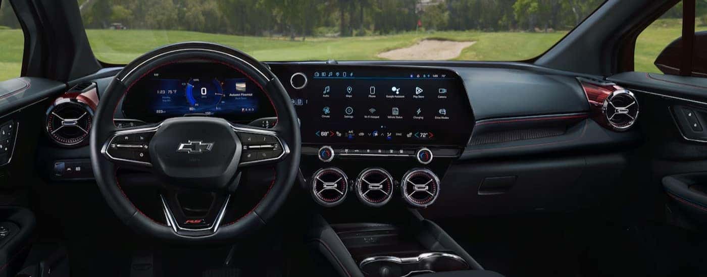 The black interior and dash are shown in a 2025 Chevy Blazer EV for sale.