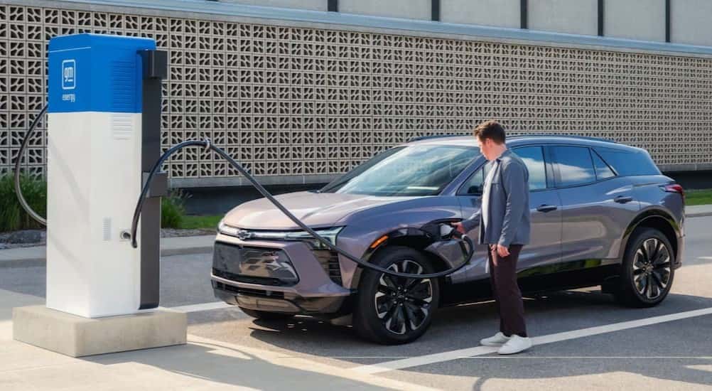 A gray 2025 Chevy Blazer EV RS is shown charging at a charge station.