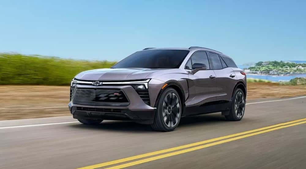A gray 2025 Chevy Blazer EV RS is shown driving on a highway after viewing a Chevy Blazer EV for sale.