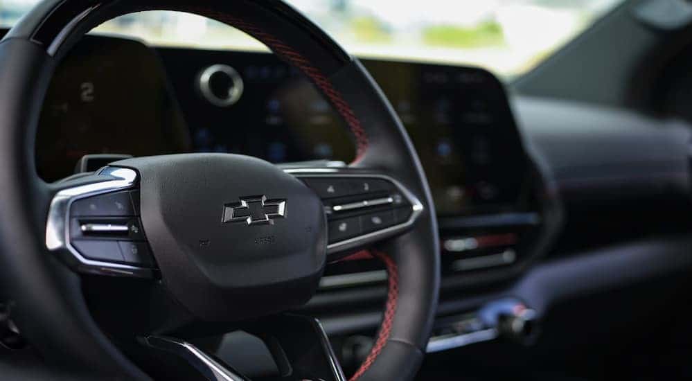 A close-up of the steering wheel is shown in a 2025 Chevy Silverado EV for sale.
