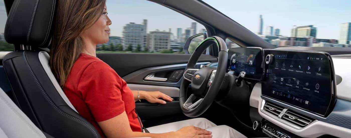 The black and white interior and dash are shown in a 2024 Chevy Equinox EV For sale near Mint Hill.