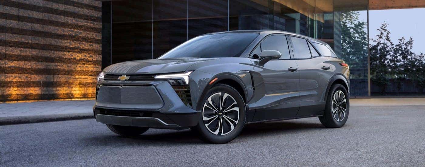 A grey 2025 Chevy Blazer EV for sale in Charlotte parked outside a building.