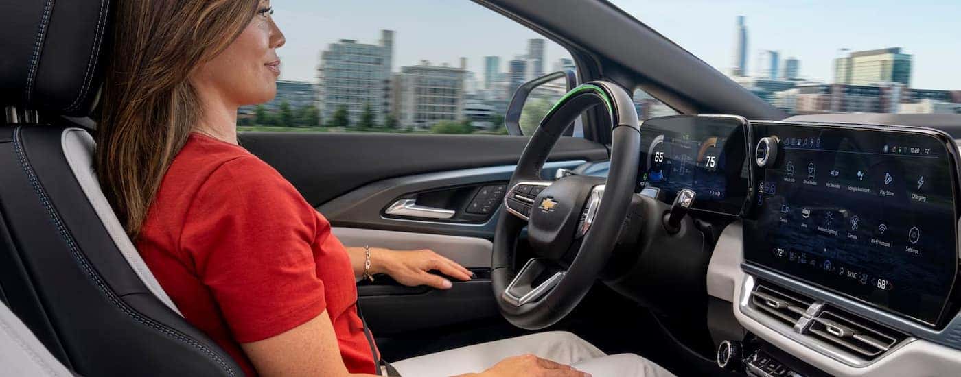 A woman is using the Super Cruise feature in a 2025 Chevy Equinox EV.