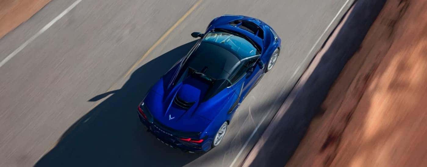 A blue 2025 Chevy Corvette ZR1 driving to a Chevy dealer near Belmont