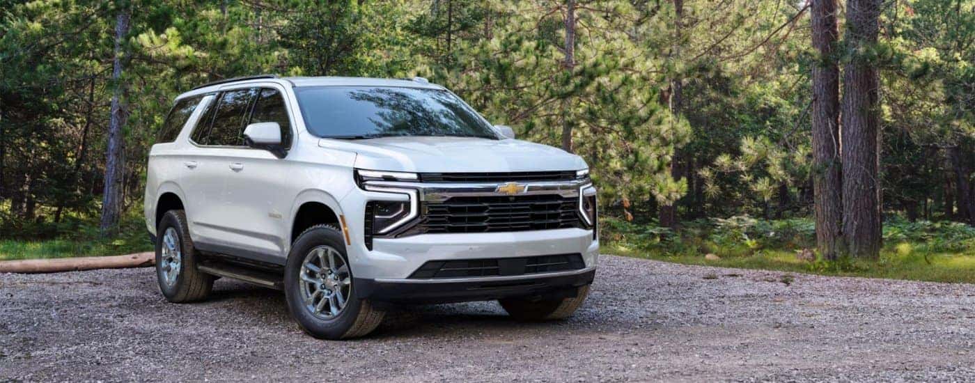A white 2025 Chevy Tahoe on a gravel lot.