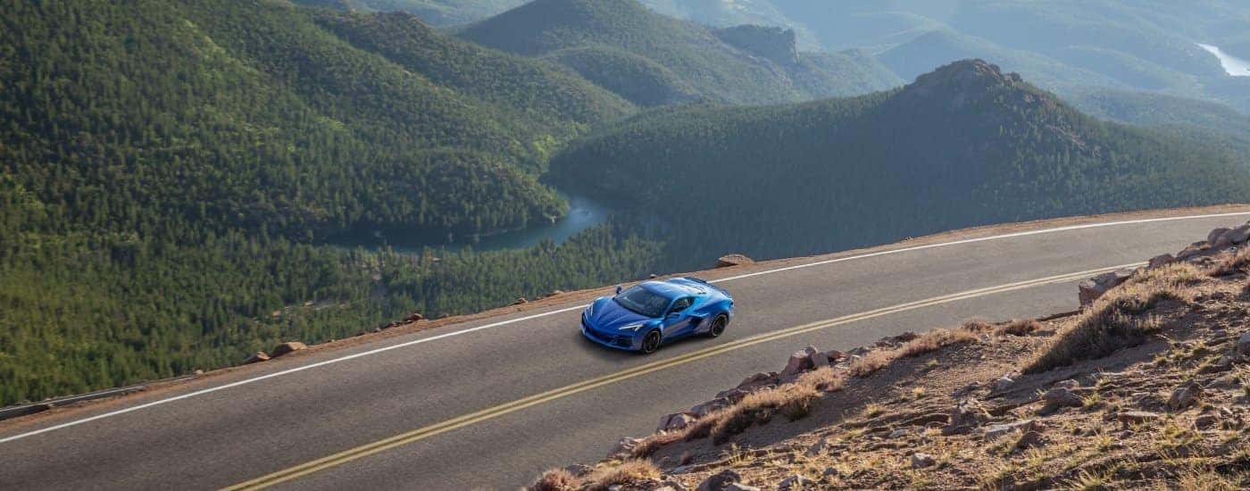 A blue 2024 Chevy Corvette E-Ray 3LZ driving to a Chevy dealer near Gastonia.