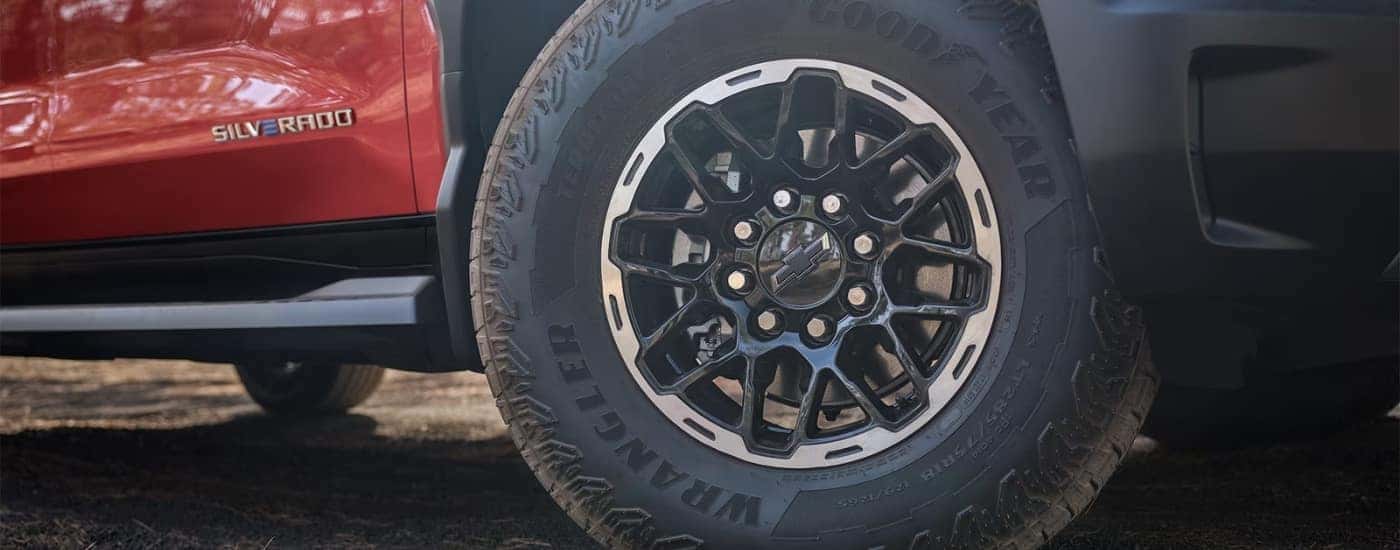A wheel on an orange 2026 Chevy Silverado EV TrailBoss.