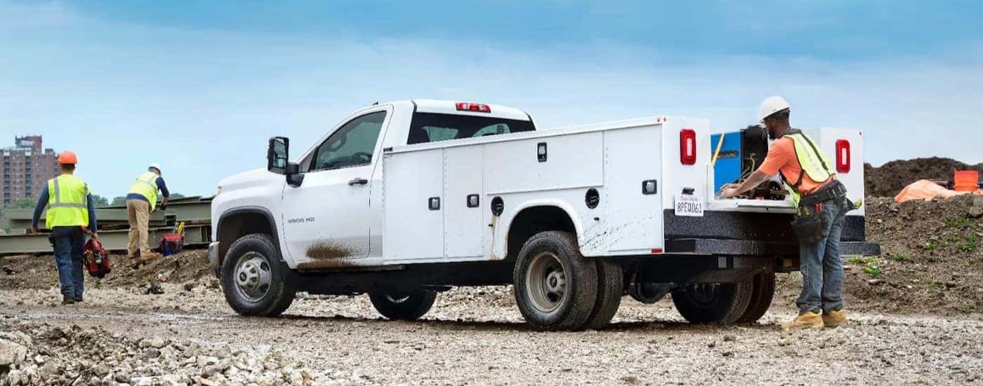 A white 2024 Chevy Silverado 3500 parked on a construction site.