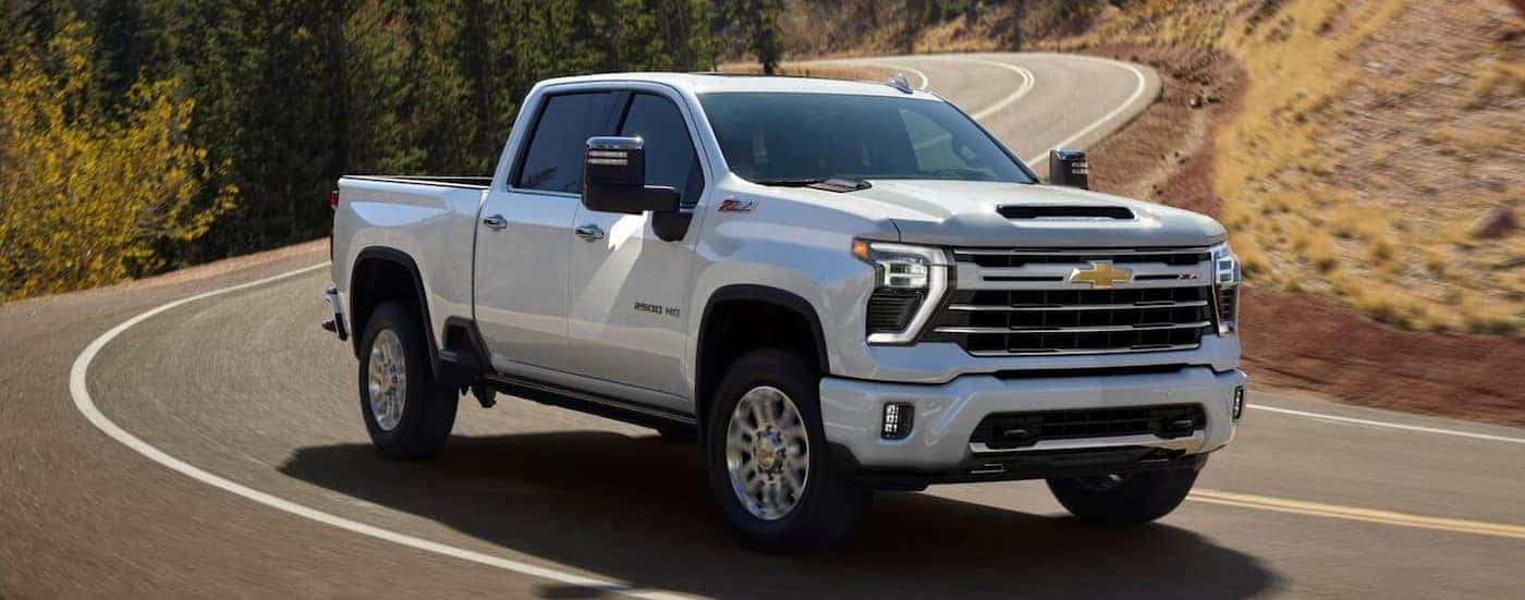 A white 2025 Chevy Silverado 2500 Z71 driving on a highway.