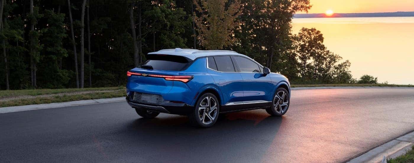 A blue 2024 Chevy Equinox EV for sale near Kannapolis at sunset.