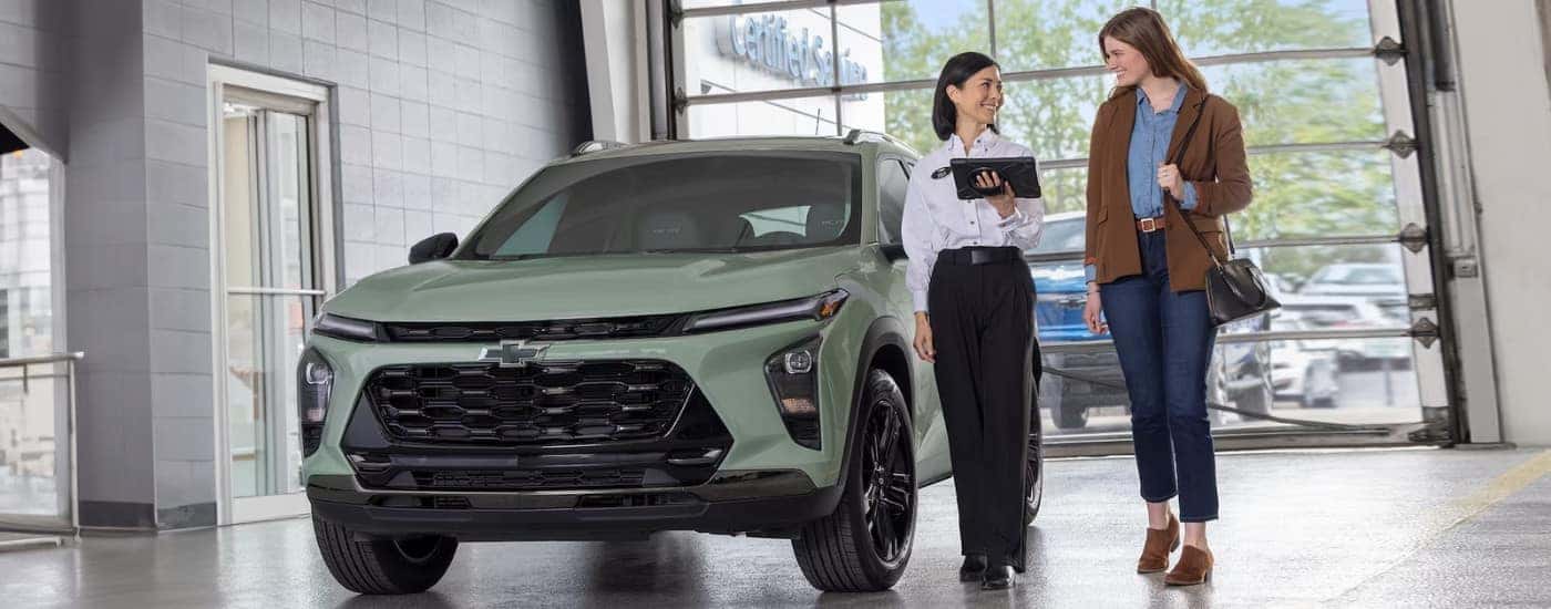 A green 2024 Chevy Trax in a dealership.